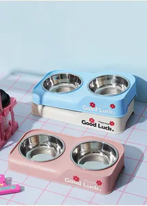 Detailed macro view of stainless steel double pet bowls in blue, cream and pink colors