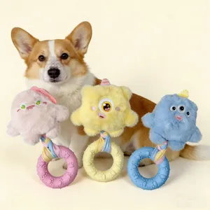 Close-up of three colorful monster dog toys with a cute Corgi on a cream background