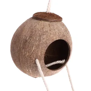 Detailed view of a natural handmade coconut shell bird nest with durable hanging ropes