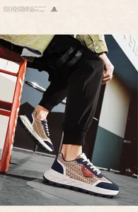 Close-up of men's casual retro sneakers with woven tweed pattern and navy blue accents.