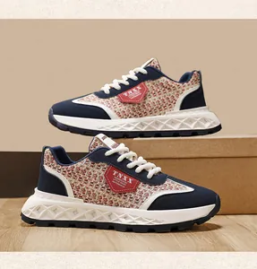 Detailed side view of vintage tweed sneakers with navy blue suede and white laces
