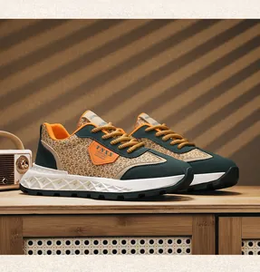 Detailed side view of retro woven men's sneakers with green suede and orange accents