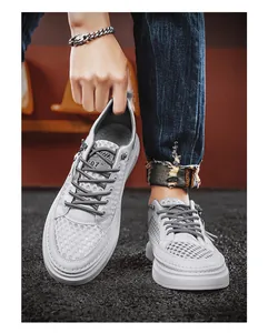 Detail view of men's breathable grey mesh hollow casual sneakers in urban street style.