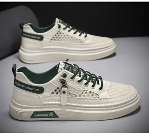 Detailed view of cream mesh breathable sneakers with green accents and side zipper.
