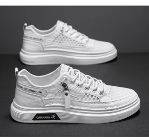 Macro view of white men's sneakers featuring breathable mesh panels and side zipper detail