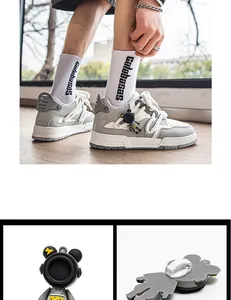 Détail de l'attache astronaute amovible sur baskets grises pour hommes.