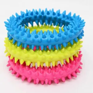 Close-up detail of three colorful TPR spiked dog chew rings for teeth cleaning