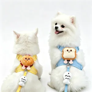 Close-up of cute hamburger and toast plush dog harnesses on white Pomeranians.