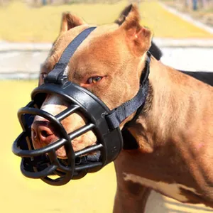Detail view of a durable black basket-style dog muzzle worn by a large dog outdoors