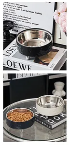 Close-up of elevated stainless steel pet bowls in black and white minimalist styles