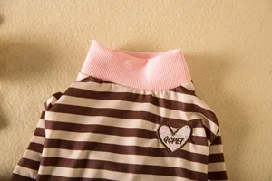 Close-up of a striped pet base shirt featuring a pink ribbed collar and heart embroidery.