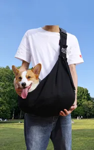 Close-up detail of a black breathable pet sling bag with a Corgi dog inside for travel