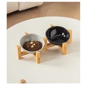 Detail view of slanted ceramic pet bowls on minimalist bamboo stand for neck protection