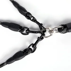 Close-up view of durable metal clips on a 3-way reflective nylon dog leash coupler.