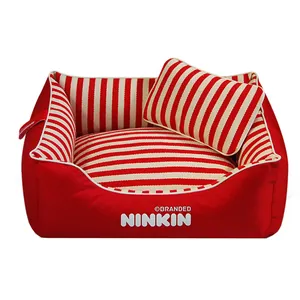 Detail showing the red and white striped interior and matching pillow of a durable canvas pet bed