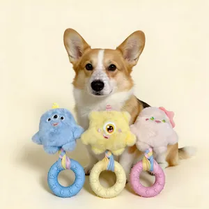 Set of three colorful little monster squeaky dog toys with teething rings and a Corgi