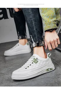 Detailed side view of white casual sneakers featuring green accents and textured panels