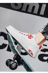 Detailed macro view of white street-style casual sneakers with red accents on a skateboard