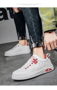 Close-up of white fashion sneakers with red accents and embossed pattern for men