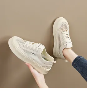 Detailopname van ademende crème kanten plateau sneakers met fijn bloemenpatroon