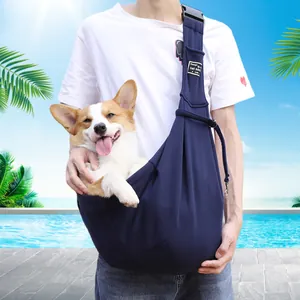 Adjustable navy blue pet sling carrier for dogs and cats on a person's shoulder