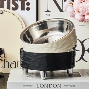 Detailed macro shot of the textured stainless steel pet bowl on a black high-leg stand.
