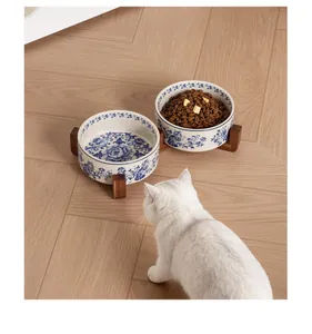 Vintage blue and white porcelain ceramic pet bowl set with acacia wood stand detail