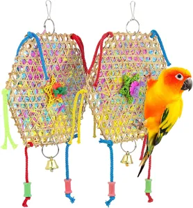 Detail of bamboo-woven bird toy with colorful shredded paper and bells for parrots.