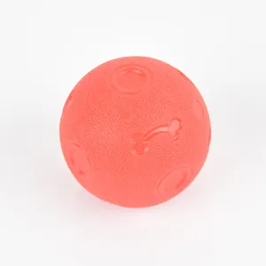 Close-up detail of red textured dog chew toy ball made of durable TPR elastic material