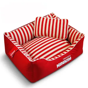 Detailed macro view of red and white striped canvas dog bed including matching pillow