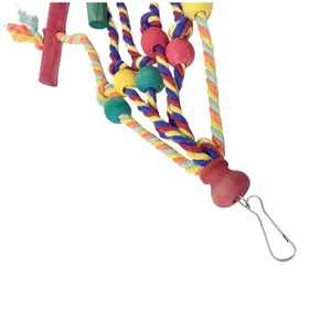 Detail view of a colorful cotton rope bird toy with wooden beads and metal clip