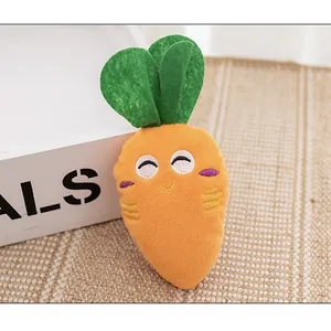 Close-up detail of plush carrot squeaky toy showing soft texture and embroidered face