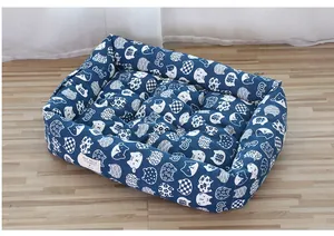 Close-up detail of the navy blue cat-patterned fabric on a thickened plush pet nest bed
