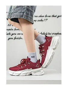 Λεπτομέρεια από μπορντό chunky sneakers με χοντρές λευκές σόλες σε μοντέλο.