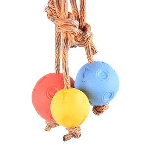 Close-up of durable TPR dog toy balls with braided rope, perfect for heavy chewing