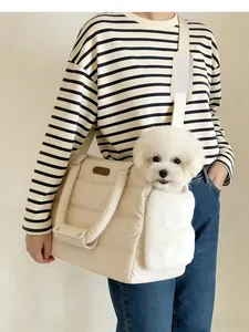 Detailed view of beige quilted pet carrier bag with a puppy inside and strap