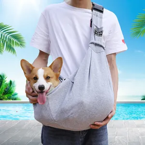 Comfortable grey adjustable pet carrier sling bag worn by owner with small dog inside