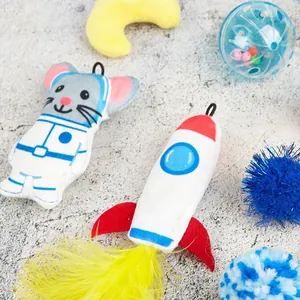Dettaglio del set di giochi per gatti con topo astronauta e razzo di peluche con piume