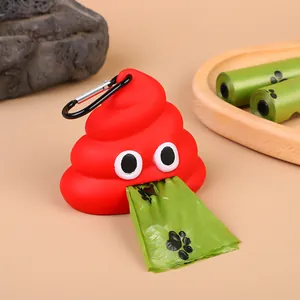 Detail view of red poop-shaped dog waste bag dispenser with carabiner and paw print bags