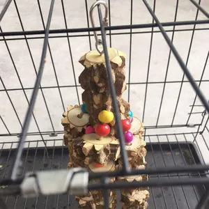Detail view of natural wood parrot toy with colorful beads hanging in a cage.