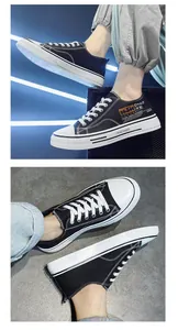 Detail shot of men's stylish black low-top canvas sneakers featuring modern side graphic