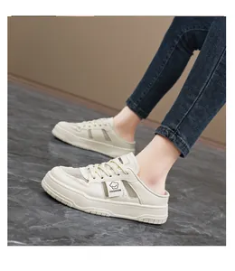 Close-up of stylish beige mesh backless sneakers worn with denim jeans on a model