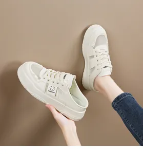 Detail view of beige platform mesh mule sneakers featuring breathable fly-woven knit upper