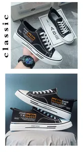 Detail view of stylish black canvas sneakers with contrast graphic printing and white laces.