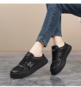 Close-up of black mesh platform mule sneakers on model for a casual summer style.