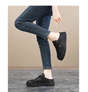 Detailed side view of black breathable mesh mule sneakers for women shown on model