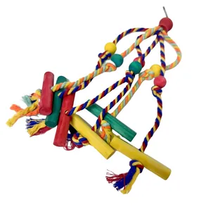 Detail view of colorful bird toy with cotton ropes and wooden blocks for chewing