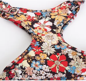 Close-up of the vibrant floral pattern and durable stitching on this pet harness detail view