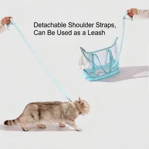 Mint blue breathable mesh pet carrier bag with detachable strap used as a leash