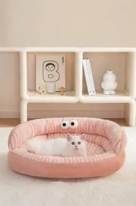 Cozy pink plush pet bed featuring a cute cartoon eye design with a white cat inside.